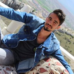 Portrait of young man sitting outdoors