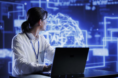 Woman using laptop at office