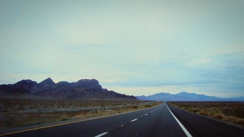 Country road leading towards mountains