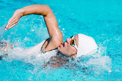 High angle view of woman swimming in pool