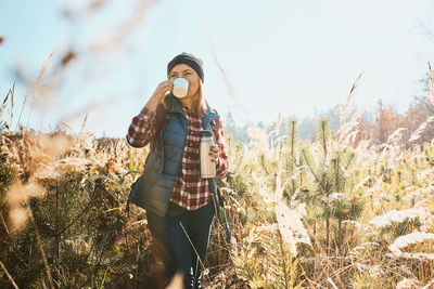 Woman enjoying the coffee in bright warm sunlight during vacation trip. leisure time close to nature