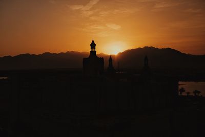Silhouette temple against sky during sunset