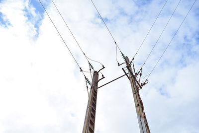 Low angle view of electricity pylon against sky