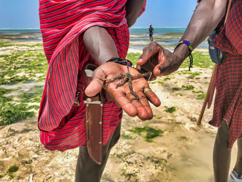 Midsection of couple holding hands