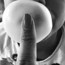 Close-up of finger touching child bubble gum