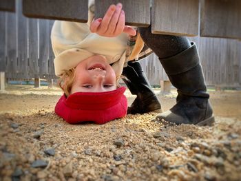 Low section of woman standing on sand at beach