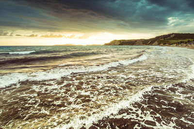 Scenic view of beach against sky during sunset