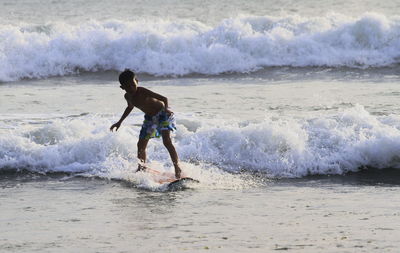 Full length of man surfing in sea