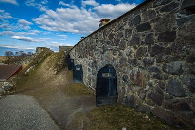 Old building against cloudy sky