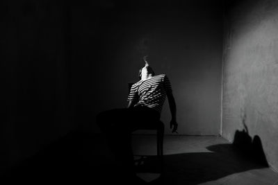 Man smoking in darkroom