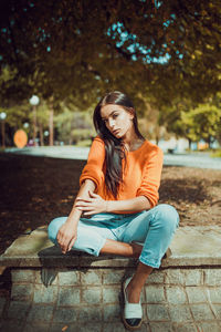 Portrait of a young woman sitting outdoors