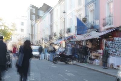 People walking on road along buildings