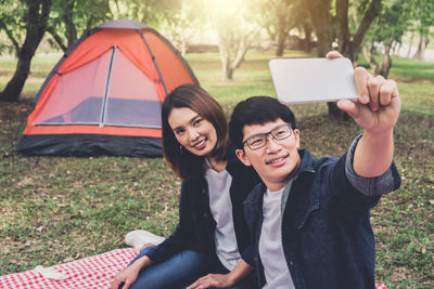 Couple taking selfie in park