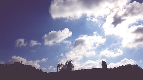 Low angle view of silhouette land against sky