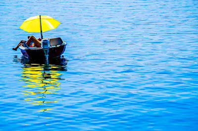 View of boats in calm blue sea