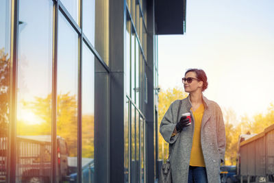 Woman standing on city street during winter