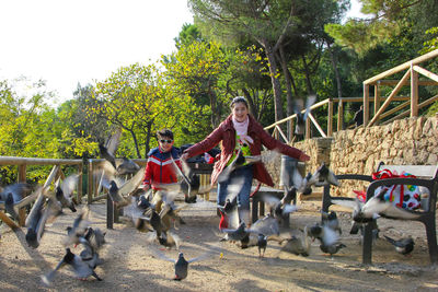 Happy playful children chasing pigeons