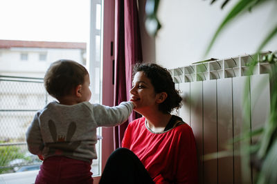 Smiling mother and daughter at home