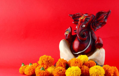 Statue of buddha against red background