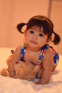 Cute baby girl on bed at home