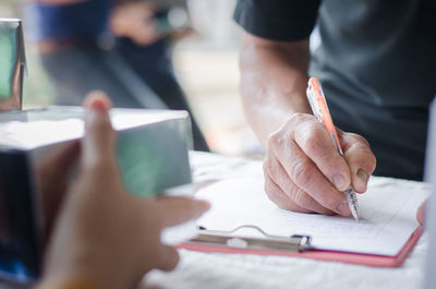 Close-up of man working on table