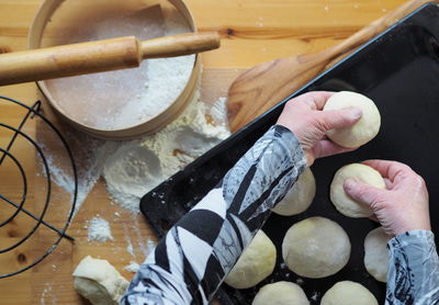 The process of cutting the dough into pieces for baking homemade buns.the woman's hands 