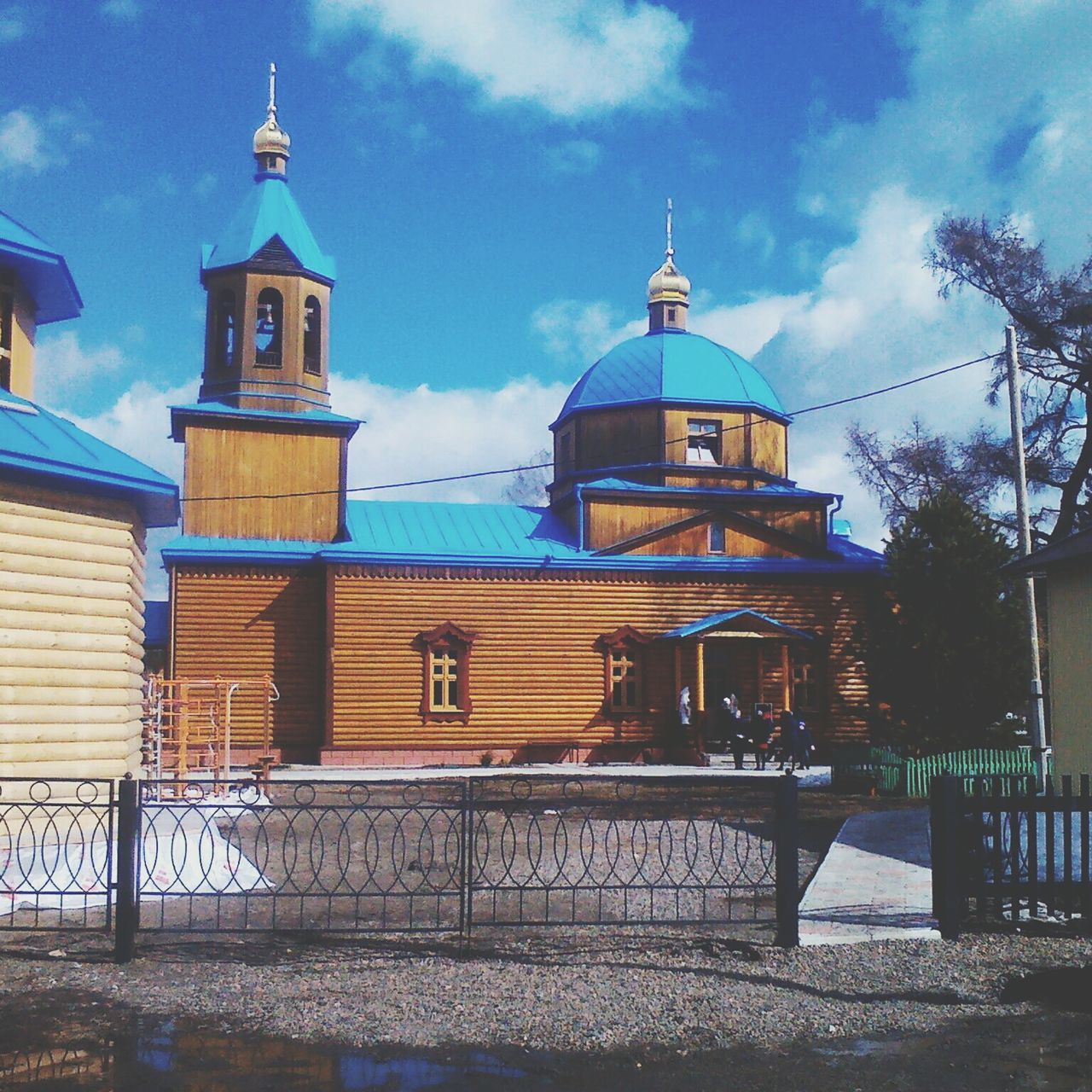 architecture, building exterior, built structure, sky, cloud - sky, blue, cloud, lighthouse, water, dome, protection, railing, day, tower, outdoors, cloudy, safety, place of worship, incidental people, guidance