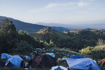 Group of people on mountain range against sky