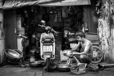 A man is working in his motorcycle workshop from saigon, vietnam.
