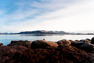 Rocks on beach against sky