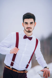 Portrait of young man standing outdoors