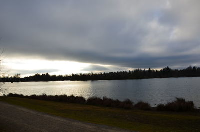 Scenic view of lake against cloudy sky