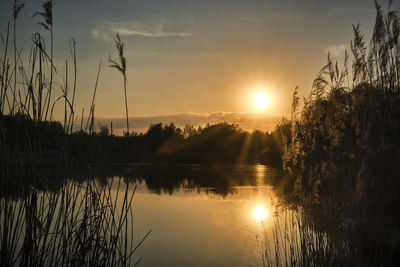 Scenic view of lake against sky during sunset