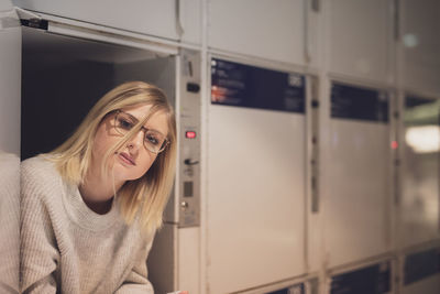 Portrait of young woman in locker