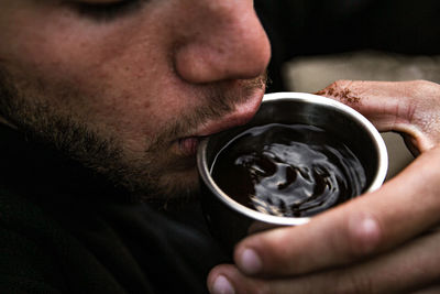 Close-up of man drinking coffee