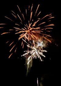 Low angle view of firework display against sky at night