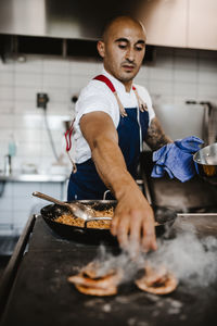 Full length of man preparing food in kitchen