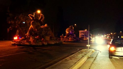 Statue in city at night