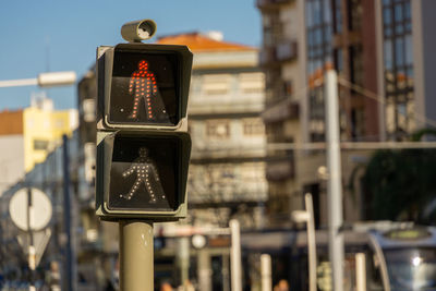 Close-up of road sign against buildings