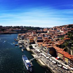 High angle view of townscape by sea against sky