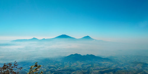 Scenic view of mountains against clear blue sky