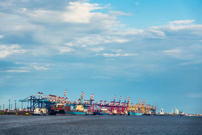 Commercial dock by sea against sky