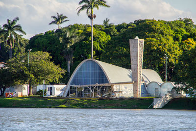 Building by river against sky