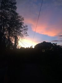 Low angle view of silhouette trees against sky during sunset