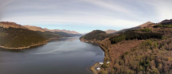 Scenic view of river and mountains against sky