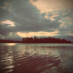 View of calm lake against cloudy sky