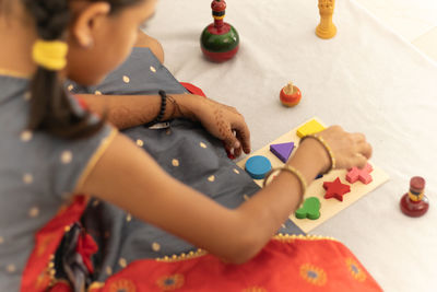 High angle view of boy playing with toy at home