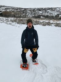 Full length of father and daughter on field during winter