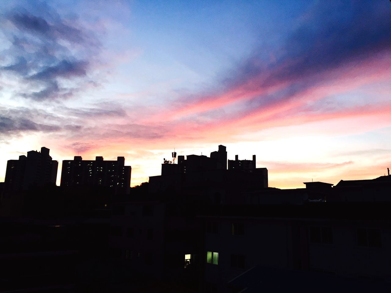 sunset, building exterior, architecture, built structure, silhouette, orange color, sky, city, cloud - sky, residential building, residential structure, building, dramatic sky, house, cloud, dark, dusk, outdoors, low angle view, no people