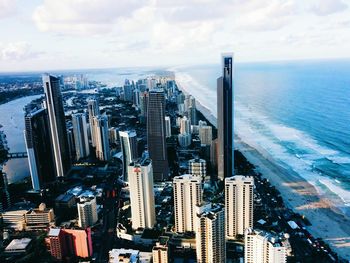 View of cityscape against cloudy sky